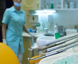 dental hygiene tools, with hygienist in background