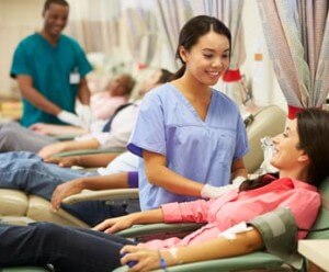 phlebotomist assisting patient