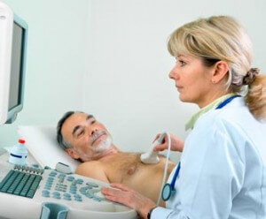 Female cardiovascular technician takes ultrasound of male patient's heart