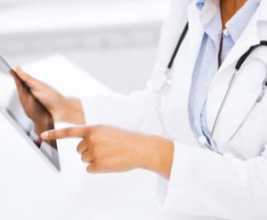 medical professional with stethoscope using ipad app