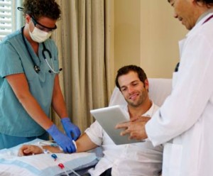 doctor and nurse consult with dialysis patient