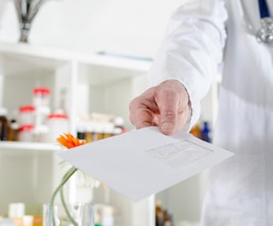doctor hands letter to lab scientist