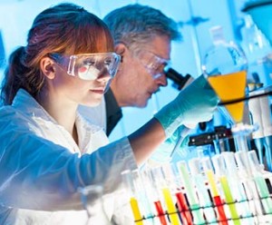 female medical lab technician in safety glasses