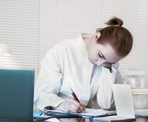 HIM student, heads down, studying, with laptop open