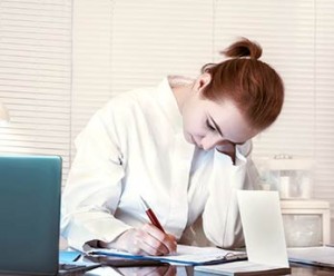HIM student, heads down, studying, with laptop open