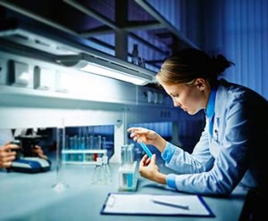 medical lab scientist examining a solution in the lab