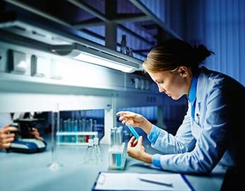 medical lab scientist examining a solution in the lab
