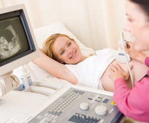 sonographer and smiling expecting mother