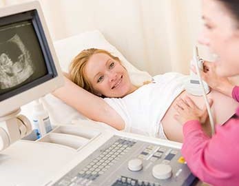 sonographer and smiling expecting mother
