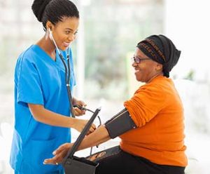 medical assistant taking a patient's blood pressure